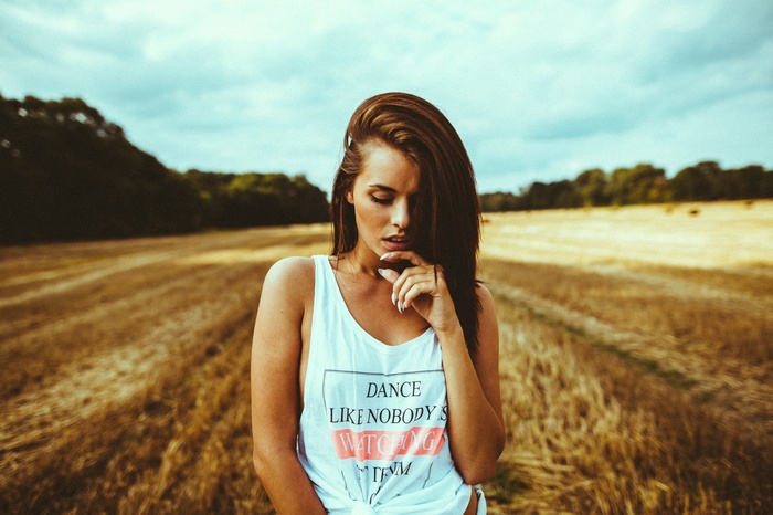 Woman in a field wearing a tank top