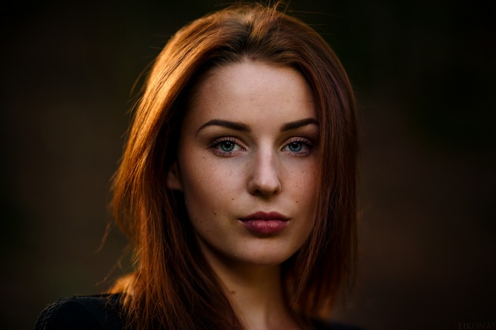 Redhead woman with freckles and green eyes portrait