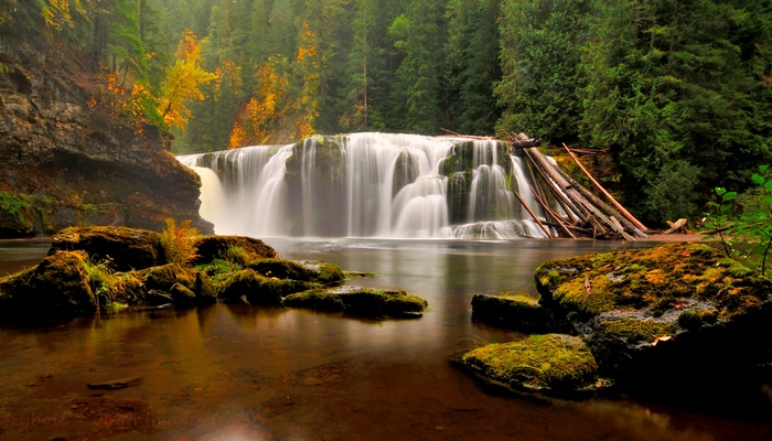 Waterfall in a forest with autumn colors