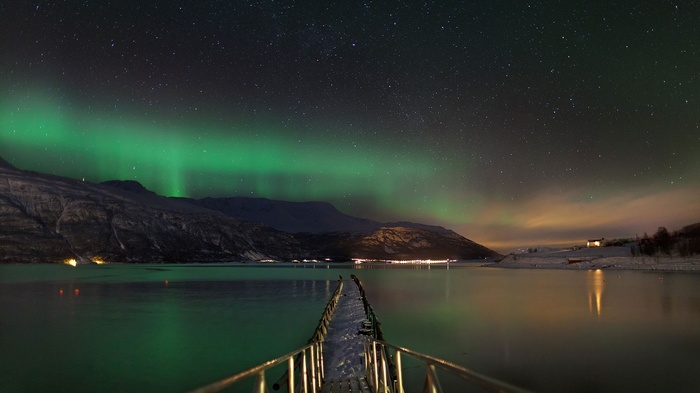 Aurora Borealis over a Norwegian Fjord with a Pier