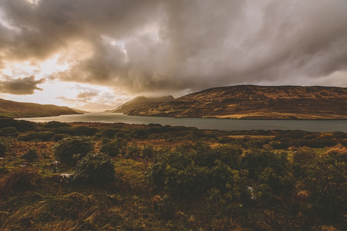 Lake and mountains under cloudy sky