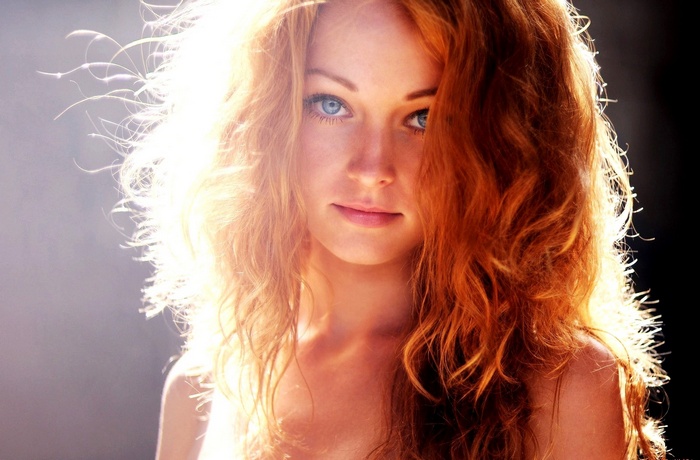 Close-up portrait of a young redhead woman