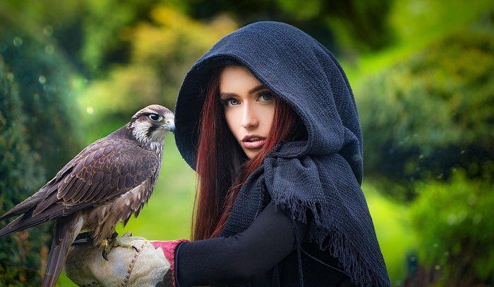 Woman in hood with falcon