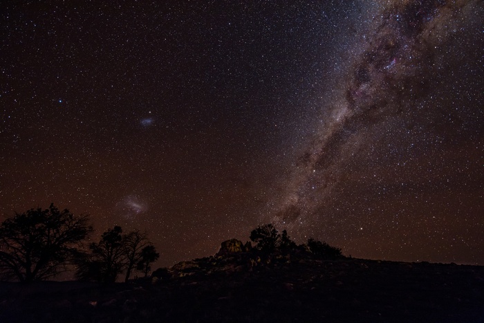 Night sky with Milky Way over silhouetted landscape