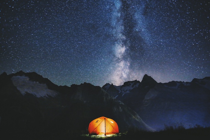 Tent under the Milky Way in mountains