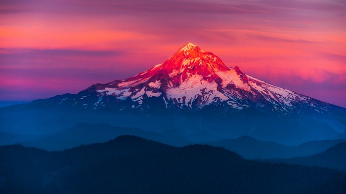 Snow-capped mountain at sunset with colorful sky