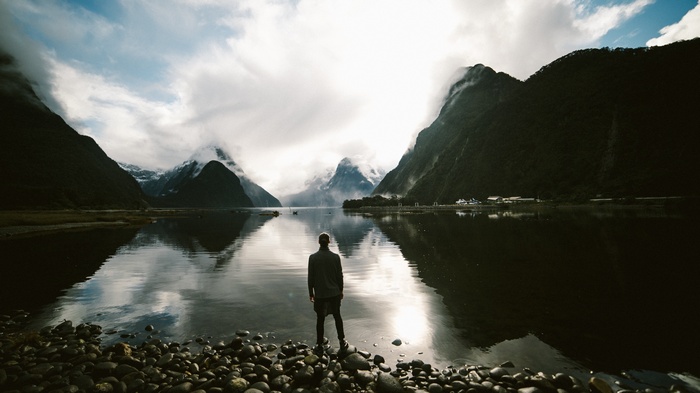 Man standing at Milford Sound, New Zealand