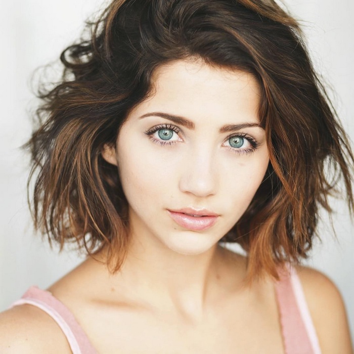 Emily Rudd portrait with short brown hair and blue eyes