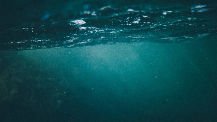 Underwater view of the ocean surface with light rays
