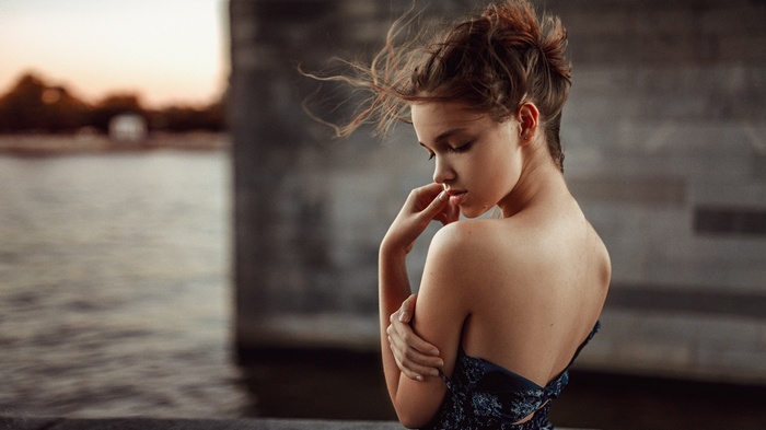Woman with bare shoulders by the water