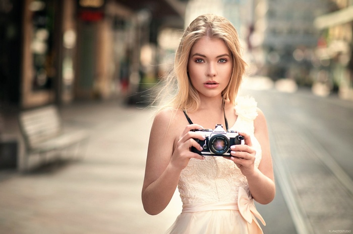 Woman holding an Olympus camera