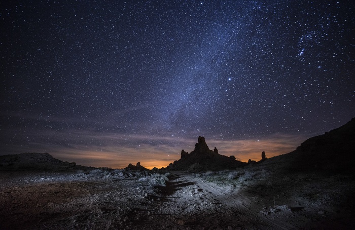 Night sky over desert rock formations