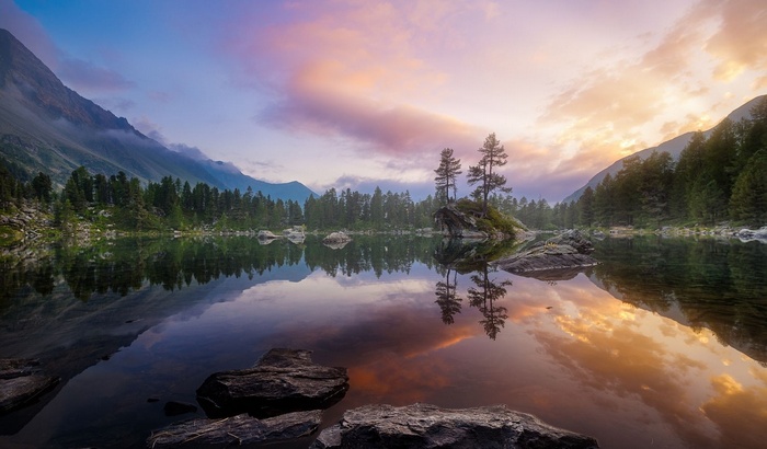 Sunset over a mountain lake with reflections