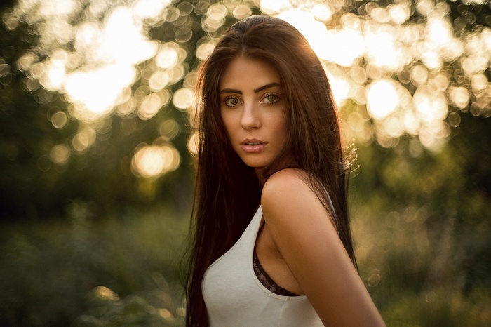 Julia Carina portrait with long hair and bokeh background