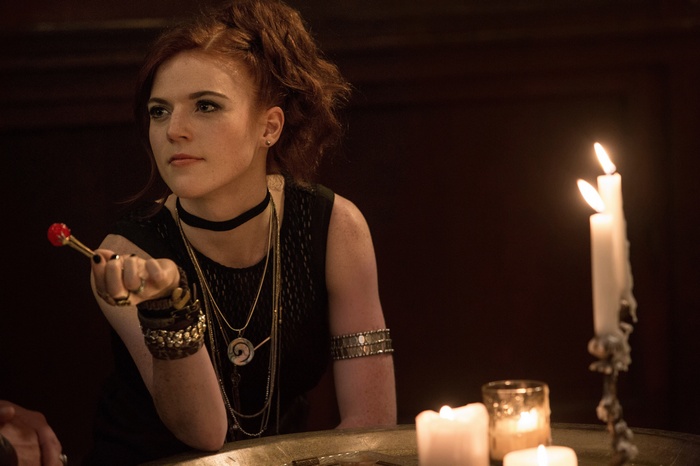 Rose Leslie holding a red object with candles