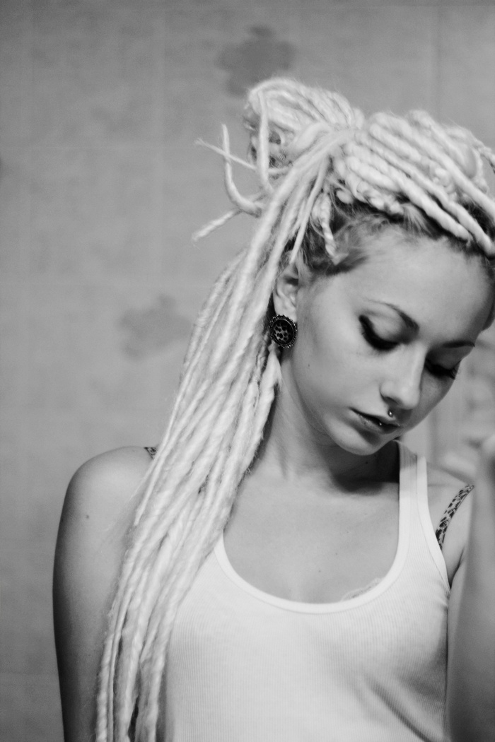 Woman with blonde dreadlocks and piercings