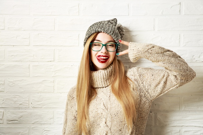 Woman in knitted sweater and beanie