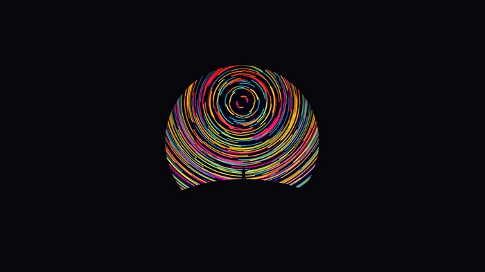 Silhouette of a man against a colorful abstract circle