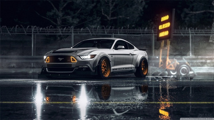 White Ford Mustang with orange rims on wet street