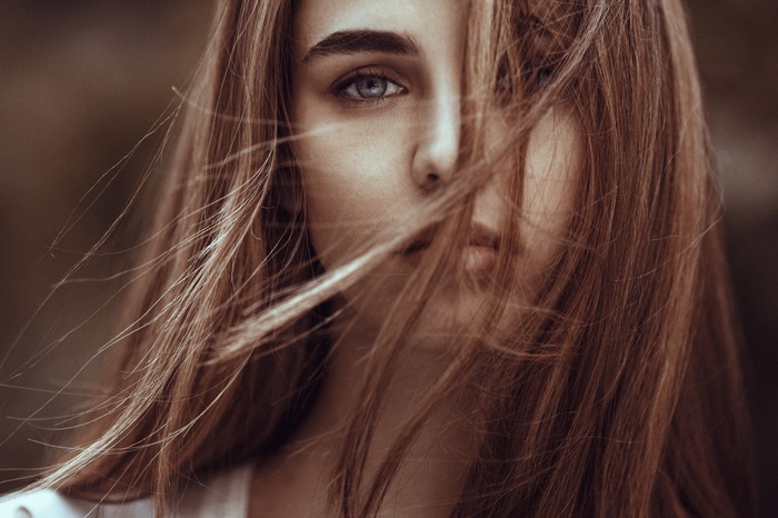 Portrait of a woman with hair in her face