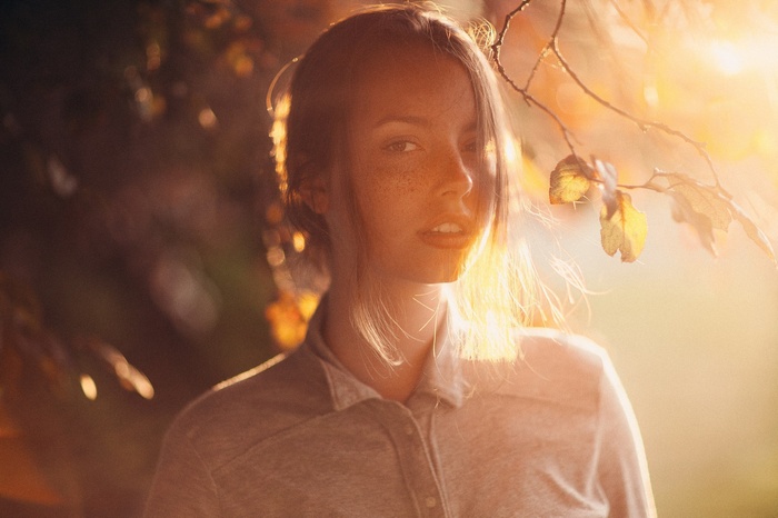 Woman with freckles in golden hour light