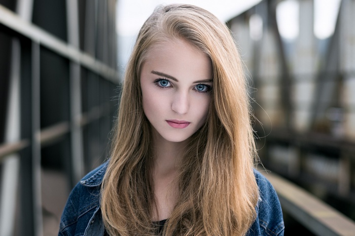 Woman with blonde hair and blue eyes outdoors