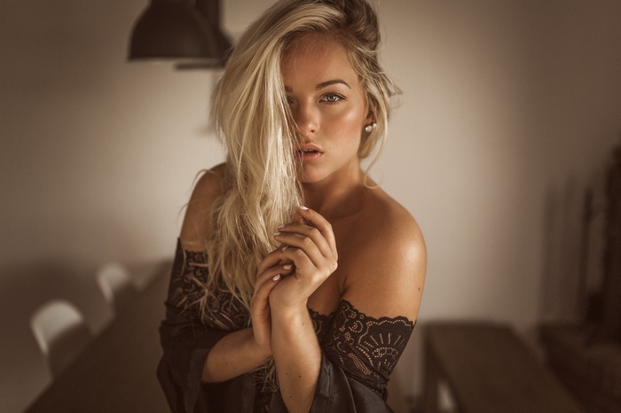 Blonde woman with blue eyes and hair in face