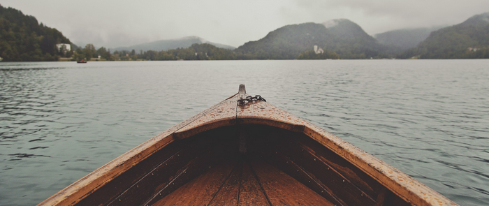 Boat on a lake with mountains in the background