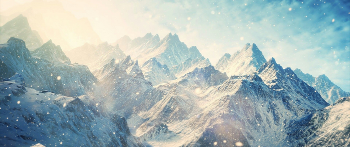 Snowy mountain range with falling snow