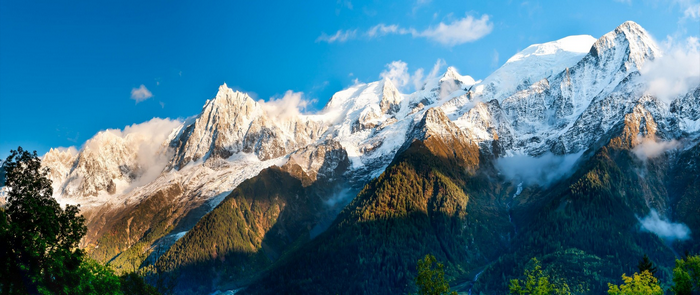 Snow-capped mountains under a blue sky