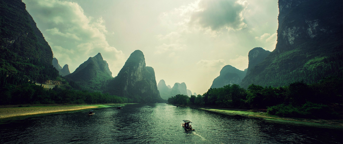 Karst mountains and river with boats