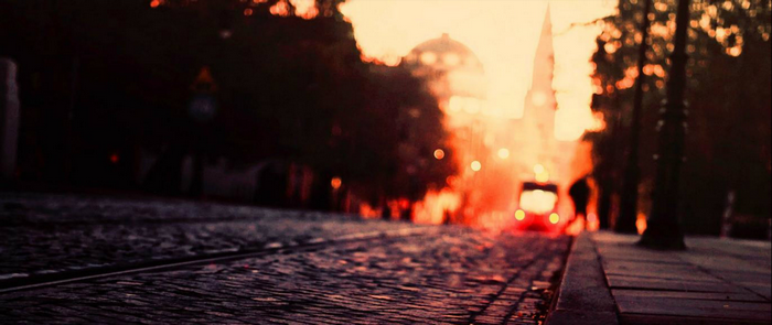 Streetcar on a cobblestone street at sunset