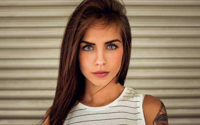 Woman with green eyes and tattoo