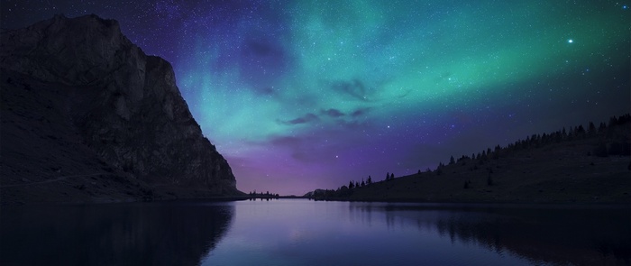 Aurora Borealis over a mountain lake
