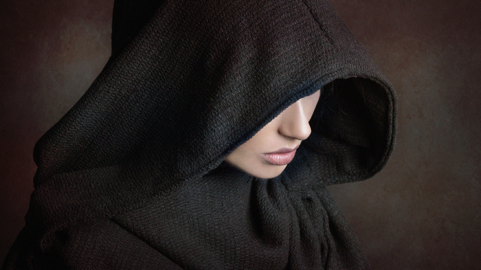 Woman in a dark hood