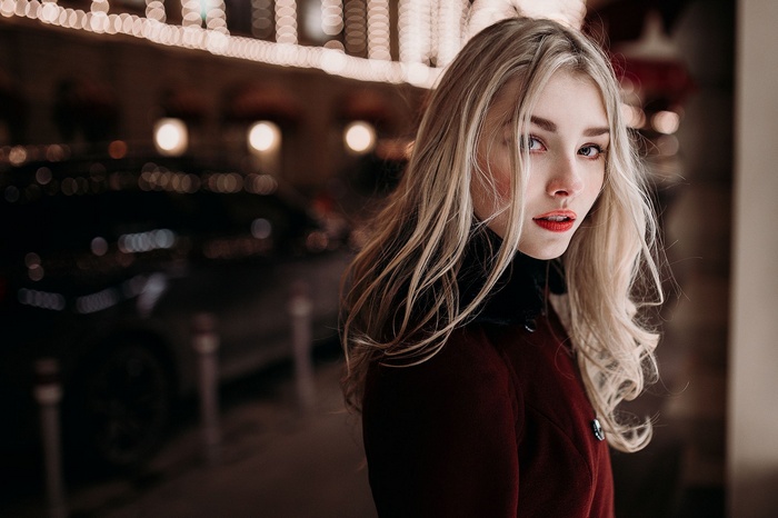 Blonde woman with red lipstick at night
