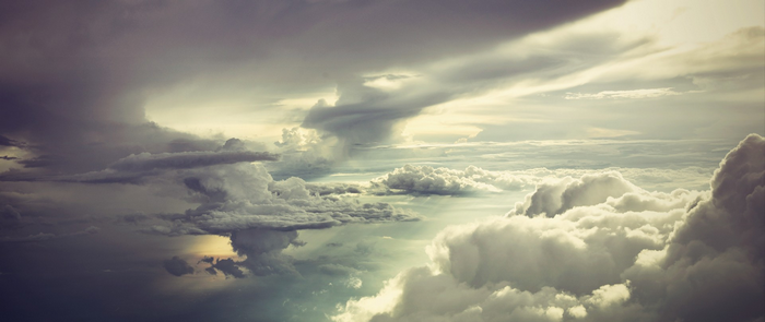 Dramatic sky with sunbeams breaking through clouds