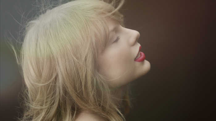 Taylor Swift with blonde hair and red lipstick
