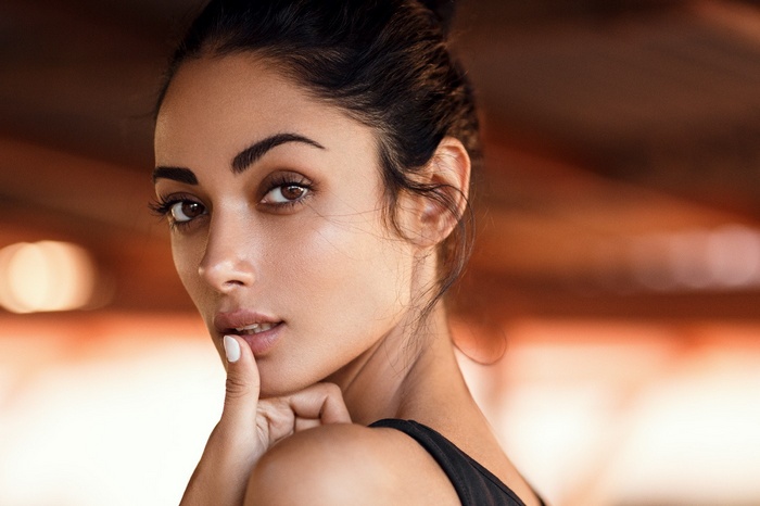 Portrait of a woman with finger on lips