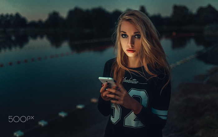 Caroline Banasik with cellphone by the water