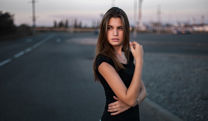 Woman in black t-shirt on a road