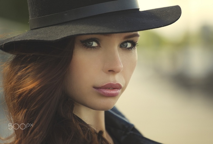 Portrait of a woman wearing a black hat