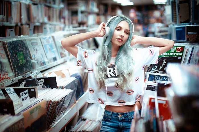 Alice Tarasenko with headphones in a record store