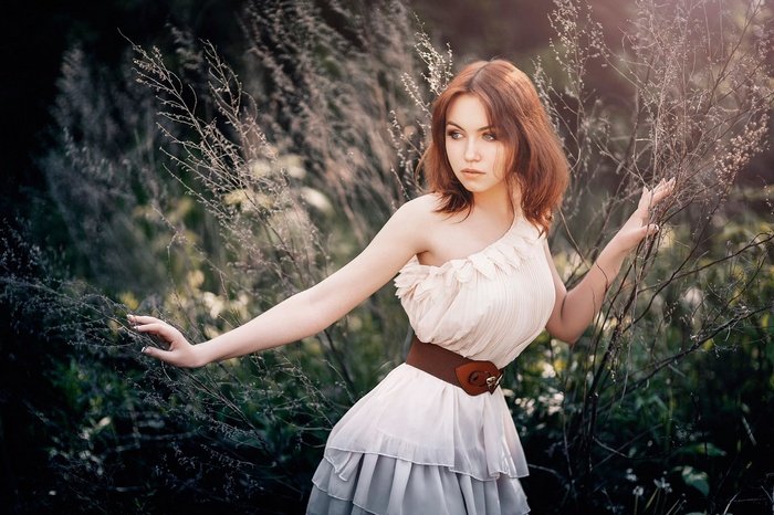 Nika Kolosova in a light dress outdoors