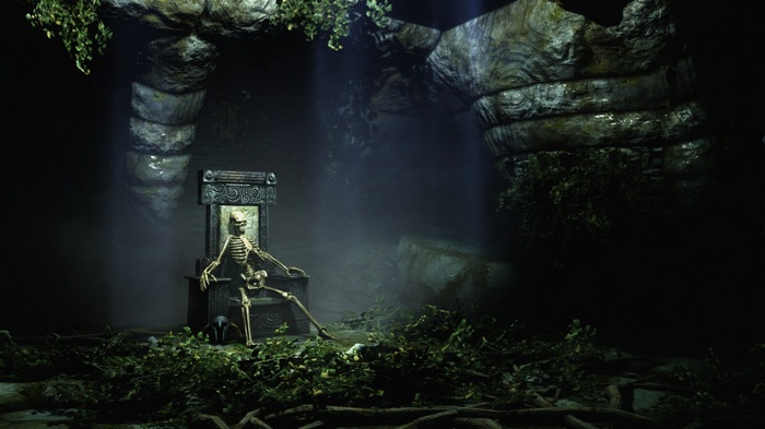 Skeleton sitting on a throne in a dark cave