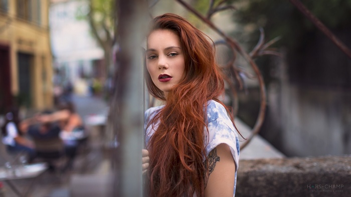 Woman with red hair and tattoo