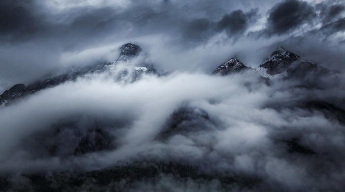 Misty mountains shrouded in dark clouds