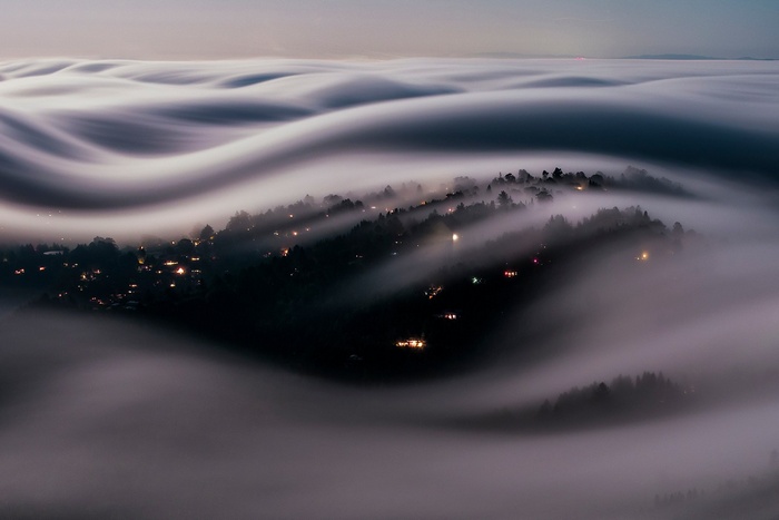 Fog rolling over a town in California at dusk