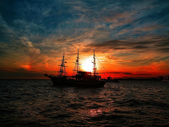 Sailing ship silhouette at sunset in Thessaloniki, Greece
