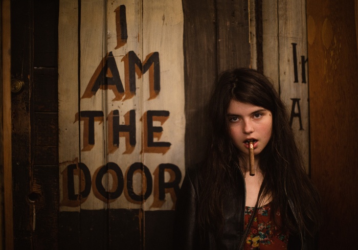 Raluca Vlad with a cigar in front of a door